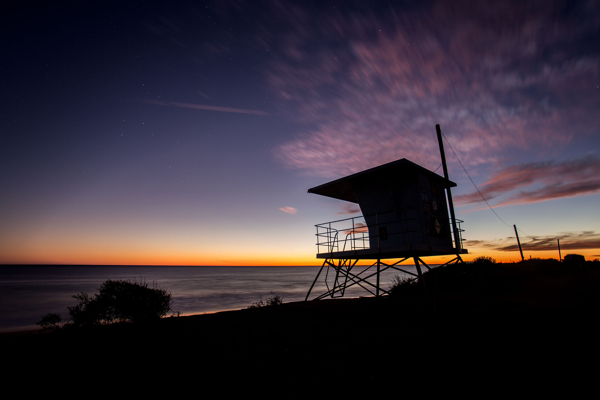 A lifeguard station at Leo Carillo Beach at sunset