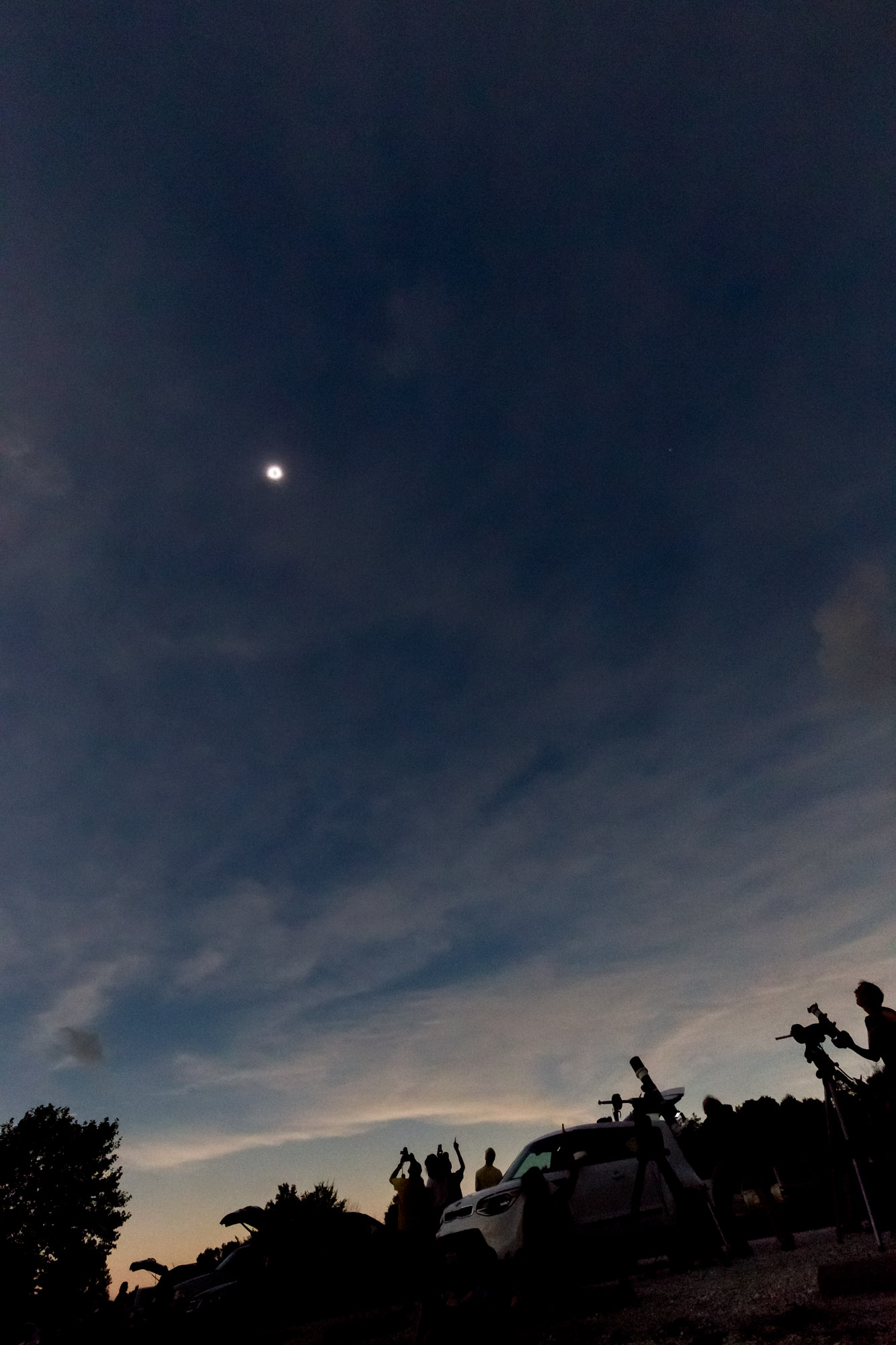 People looking up and cheering at the total eclipse