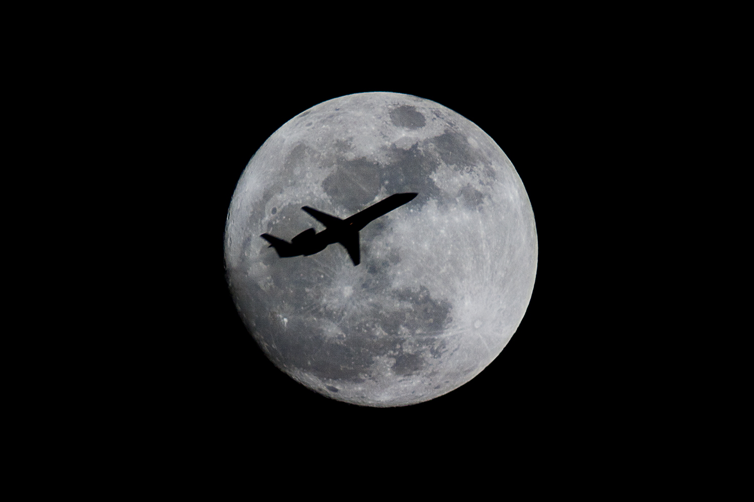 Small plane transiting the moon