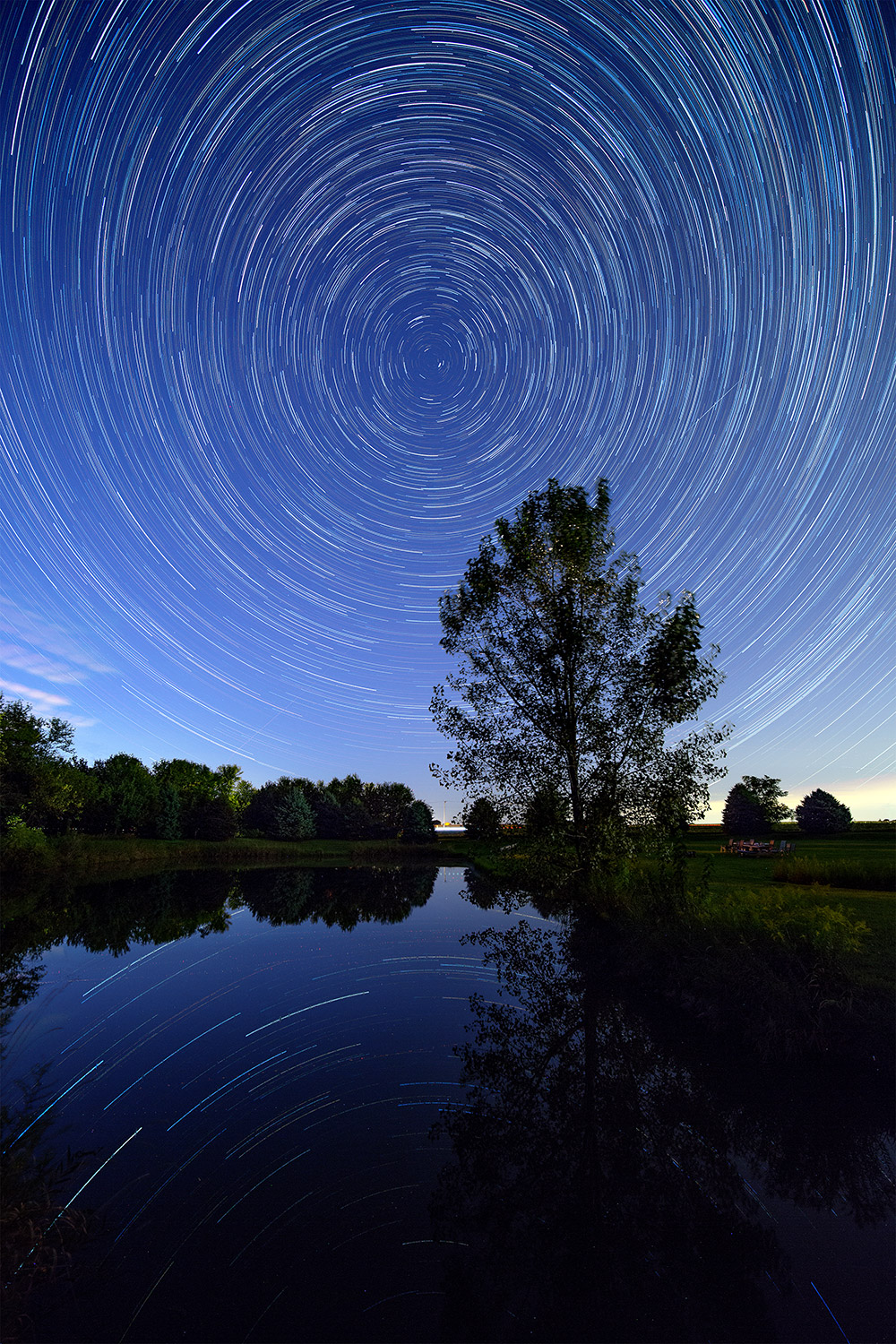 Star trails over a small lake